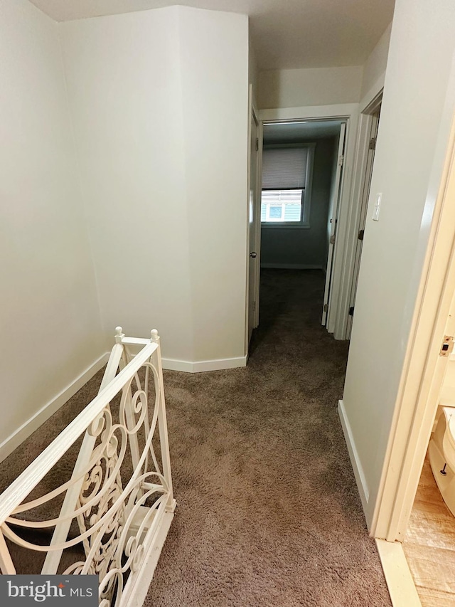 hall with carpet flooring and baseboards