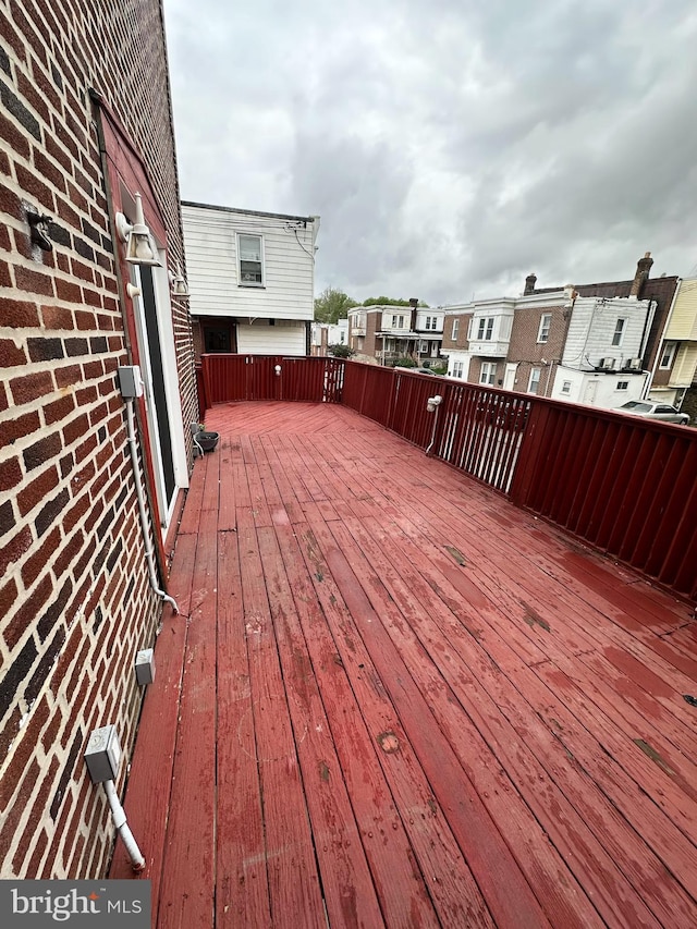 wooden deck featuring a residential view