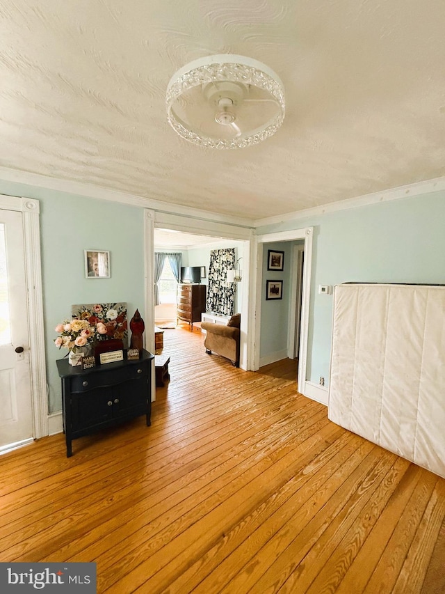 hallway with crown molding and wood-type flooring