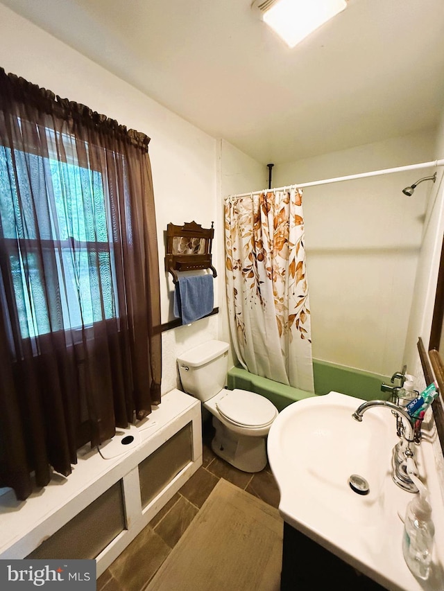 full bathroom featuring vanity, toilet, tile patterned flooring, and shower / bath combination with curtain