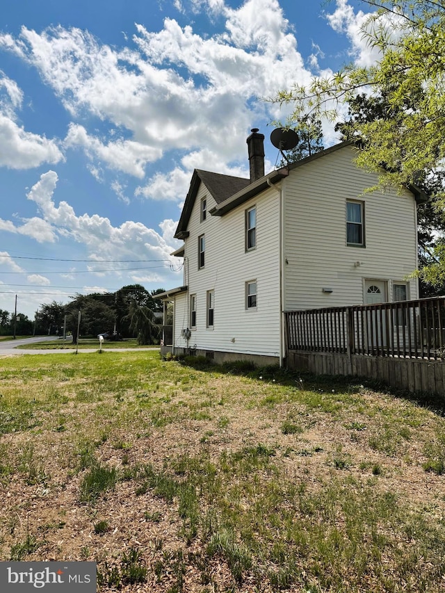 view of side of home featuring a chimney