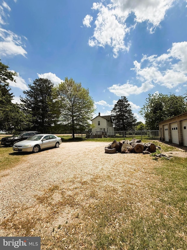 view of yard with fence and a garage