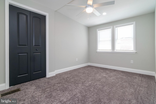 1907 E Lafayette Ave, Baltimore, MD 21213 - unfurnished bedroom featuring a ceiling fan, a closet, dark carpet, visible vents, and baseboards