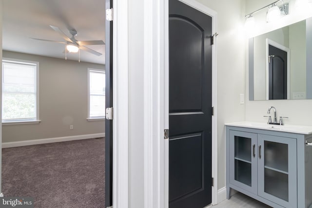 1907 E Lafayette Ave, Baltimore, MD 21213 - bathroom featuring a ceiling fan, baseboards, a healthy amount of sunlight, and vanity
