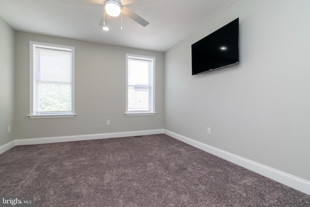 1907 E Lafayette Ave, Baltimore, MD 21213 - spare room featuring dark carpet, ceiling fan, and plenty of natural light