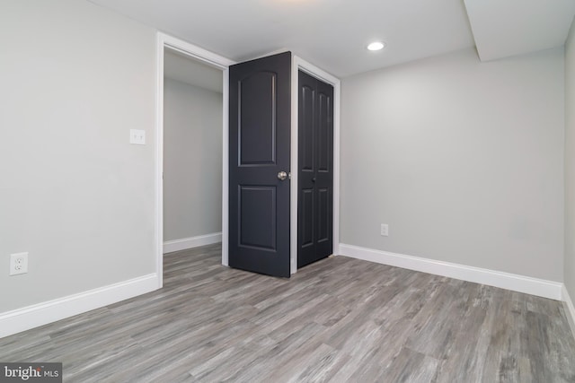 1907 E Lafayette Ave, Baltimore, MD 21213 - unfurnished bedroom featuring recessed lighting, baseboards, a closet, and wood finished floors