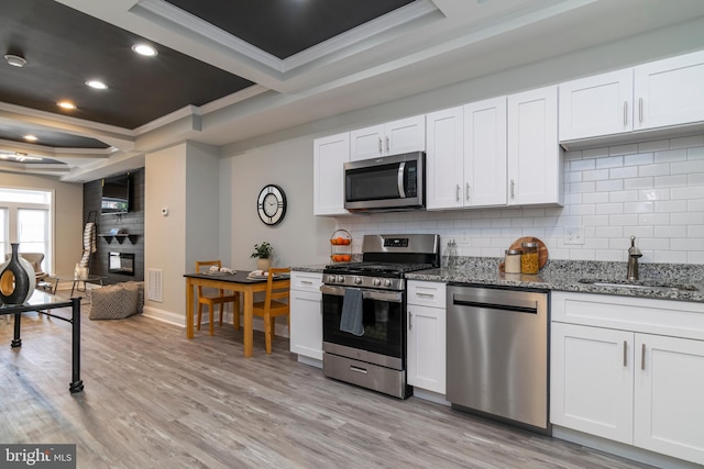 1907 E Lafayette Ave, Baltimore, MD 21213 - kitchen featuring a sink, ornamental molding, backsplash, light stone countertops, and appliances with stainless steel finishes
