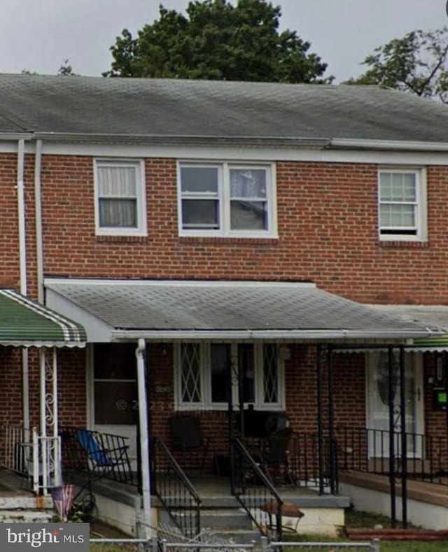 multi unit property featuring brick siding and a shingled roof