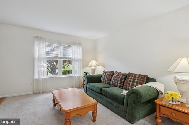 carpeted living room featuring baseboards