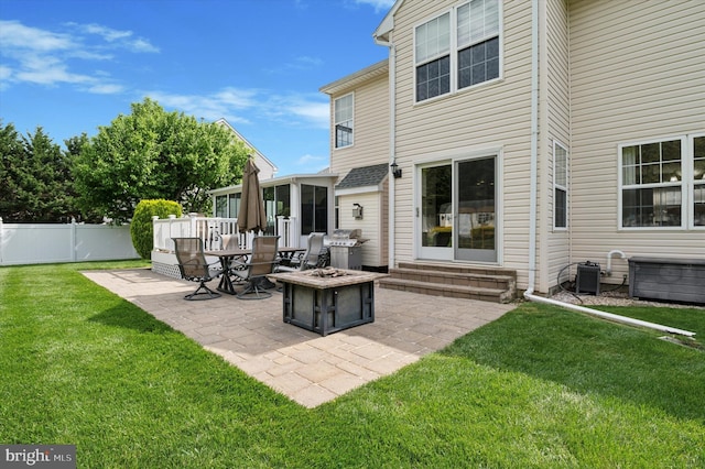 back of house with entry steps, a patio area, central AC, and a fire pit