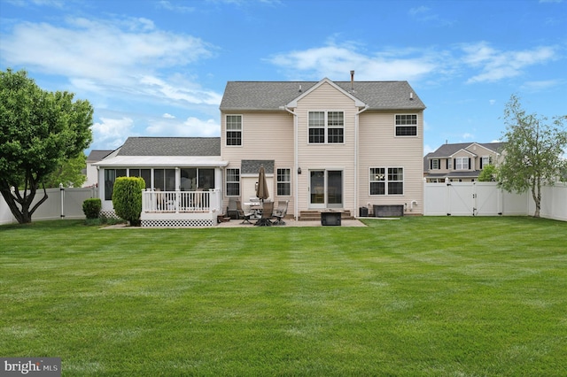 back of house featuring a gate, a sunroom, a patio, and a shingled roof