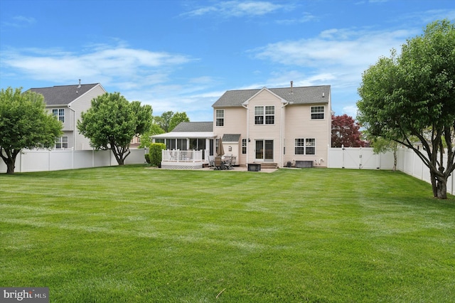 rear view of house with a sunroom and a patio