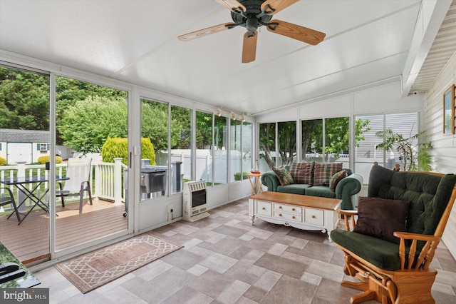 sunroom / solarium featuring outdoor lounge area, heating unit, ceiling fan, lofted ceiling, and stone finish flooring