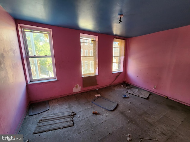empty room with baseboards and a healthy amount of sunlight