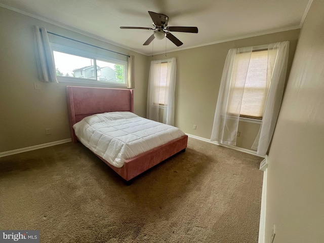 bedroom featuring carpet floors, ornamental molding, baseboards, and a ceiling fan