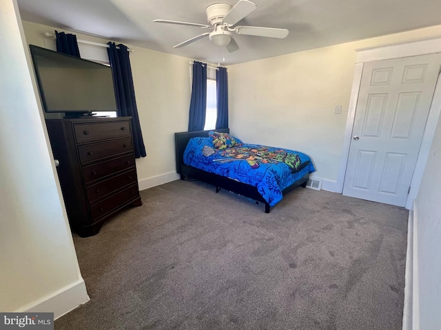 carpeted bedroom with ceiling fan and baseboards