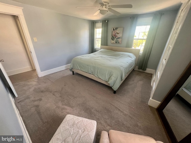 carpeted bedroom with baseboards, a ceiling fan, and multiple windows