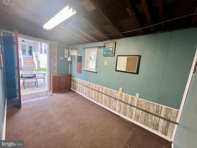spare room featuring wood walls and carpet floors