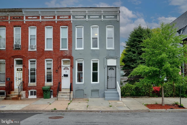 view of property with entry steps and brick siding