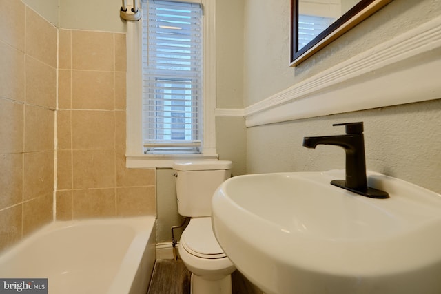 full bathroom featuring toilet and a sink