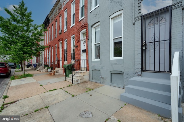 doorway to property with brick siding