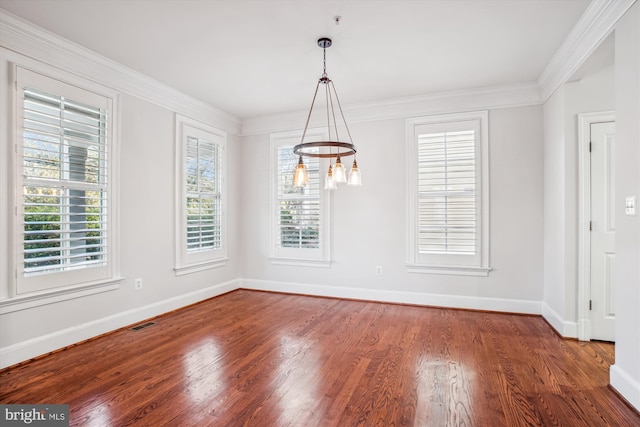 unfurnished dining area with an inviting chandelier, baseboards, visible vents, and wood finished floors