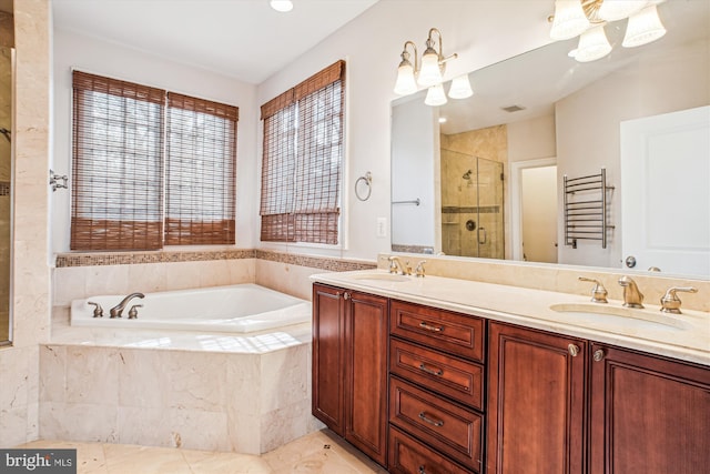 bathroom with a shower stall, a garden tub, double vanity, and a sink