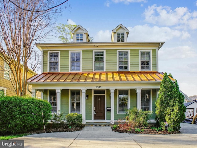 view of front of property with a porch, metal roof, and a standing seam roof