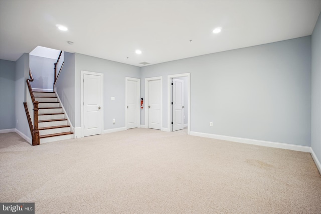 interior space featuring light carpet, baseboards, and recessed lighting
