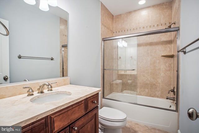 full bath featuring vanity, toilet, tile patterned flooring, and enclosed tub / shower combo
