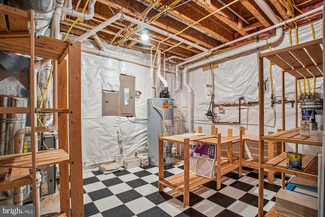 unfinished below grade area featuring tile patterned floors, water heater, and electric panel