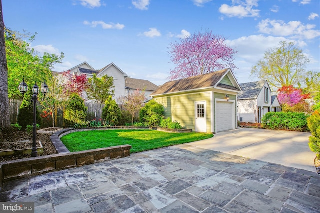 exterior space featuring an outdoor structure, a front lawn, and driveway