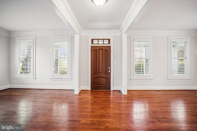 foyer entrance featuring baseboards, ornamental molding, and wood finished floors