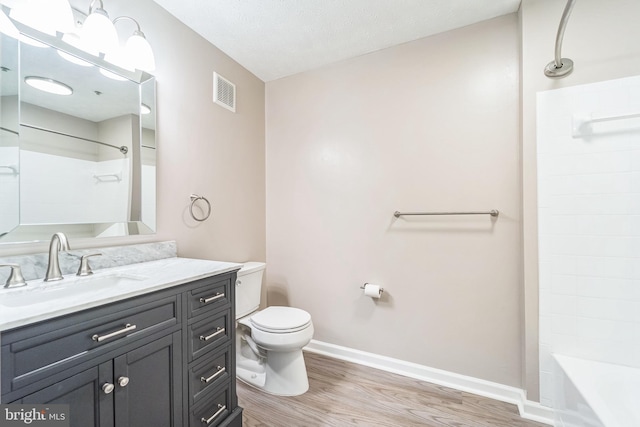 full bathroom with toilet, wood finished floors, visible vents, baseboards, and vanity