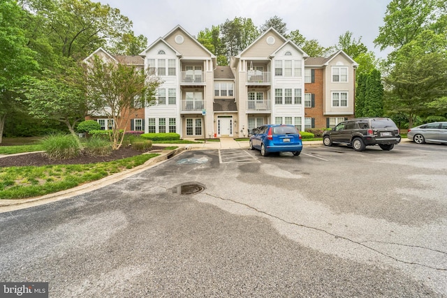 view of property featuring uncovered parking
