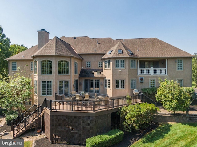 1389 Lamplighter Cir, Gwynedd, PA 19436 - rear view of property with a chimney, a deck, stucco siding, and stairs