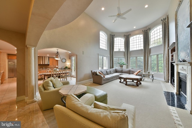 1389 Lamplighter Cir, Gwynedd, PA 19436 - living room with arched walkways, baseboards, a towering ceiling, ceiling fan, and decorative columns