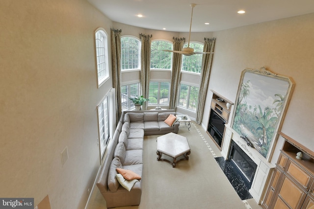 1389 Lamplighter Cir, Gwynedd, PA 19436 - living room with a towering ceiling, a high end fireplace, recessed lighting, carpet floors, and baseboards