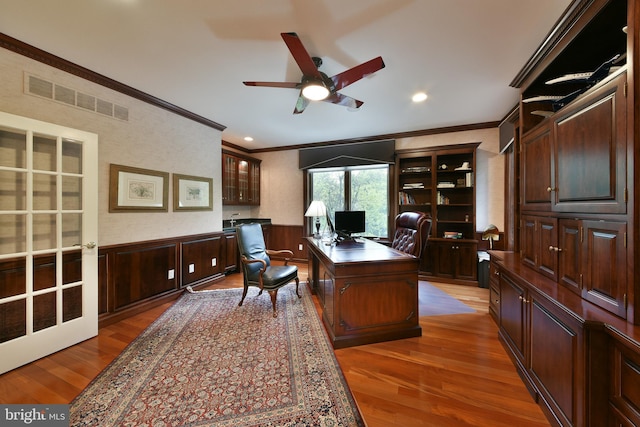 1389 Lamplighter Cir, Gwynedd, PA 19436 - home office featuring ornamental molding, wood finished floors, a ceiling fan, and a wainscoted wall