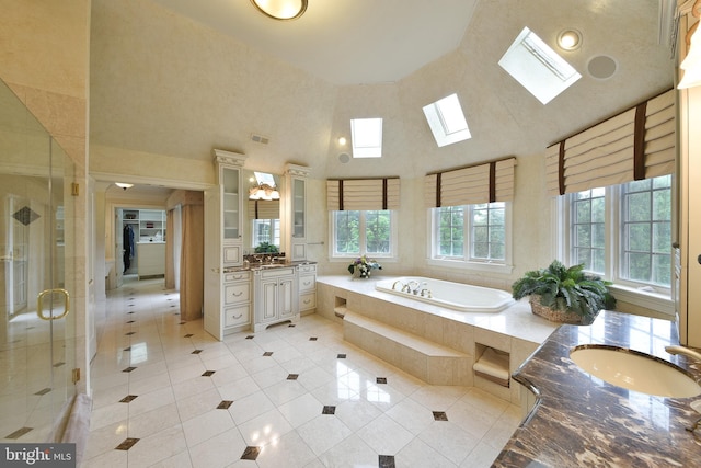 1389 Lamplighter Cir, Gwynedd, PA 19436 - full bathroom with a skylight, a towering ceiling, vanity, tile patterned floors, and a stall shower