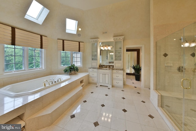1389 Lamplighter Cir, Gwynedd, PA 19436 - bathroom with a high ceiling, a skylight, tile patterned flooring, a stall shower, and a bath