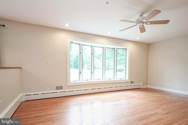 unfurnished room with a baseboard heating unit, light wood-type flooring, ceiling fan, recessed lighting, and baseboards