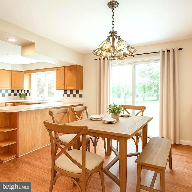 dining room with a chandelier and light wood finished floors