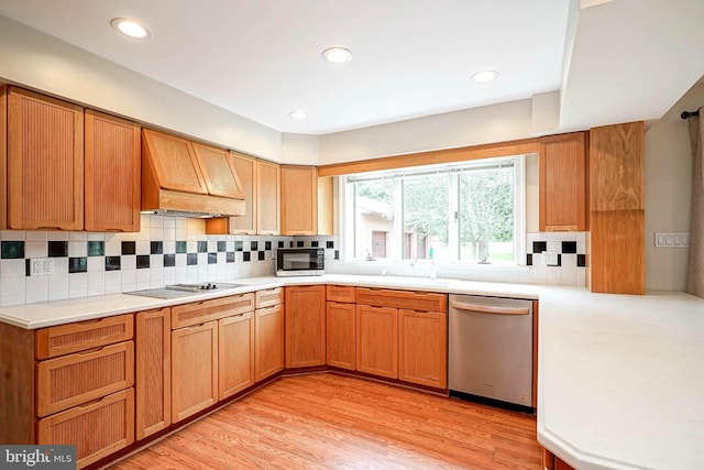 kitchen with stainless steel appliances, custom exhaust hood, tasteful backsplash, light countertops, and recessed lighting