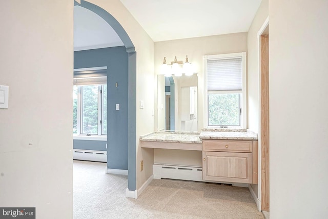 bathroom with a baseboard radiator, baseboards, and vanity