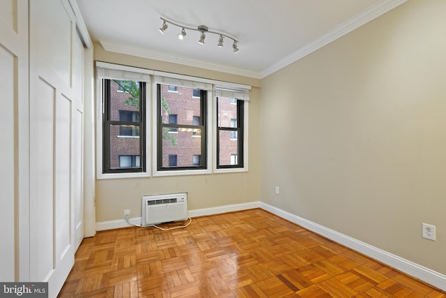 unfurnished room featuring baseboards, an AC wall unit, and crown molding