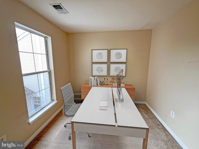 carpeted home office with baseboards and visible vents