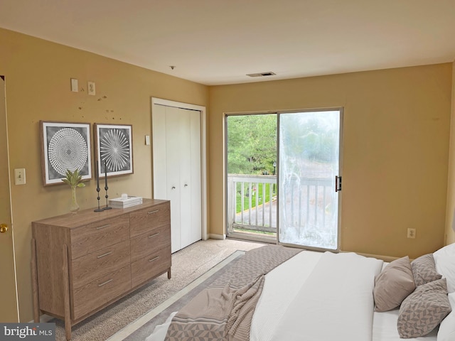 bedroom featuring visible vents, light colored carpet, and access to exterior