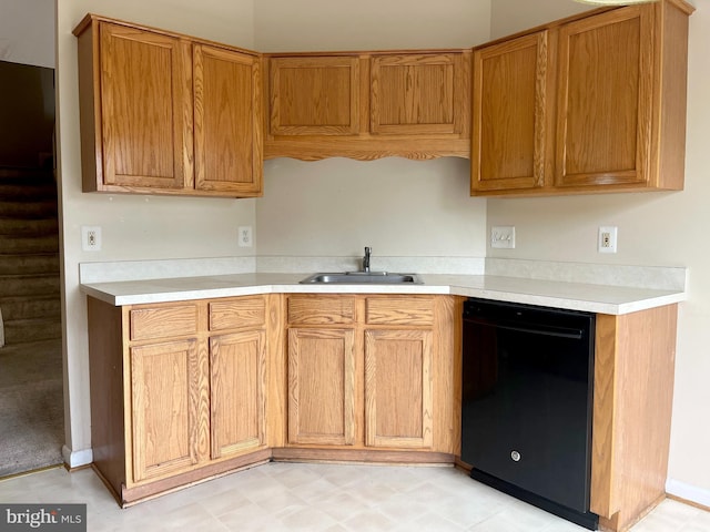 kitchen with light countertops, a sink, and dishwasher