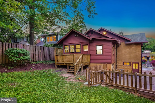 7507 Carroll Ave, Takoma Park, MD 20912 - back of property at dusk featuring a deck, a fenced backyard, and roof with shingles